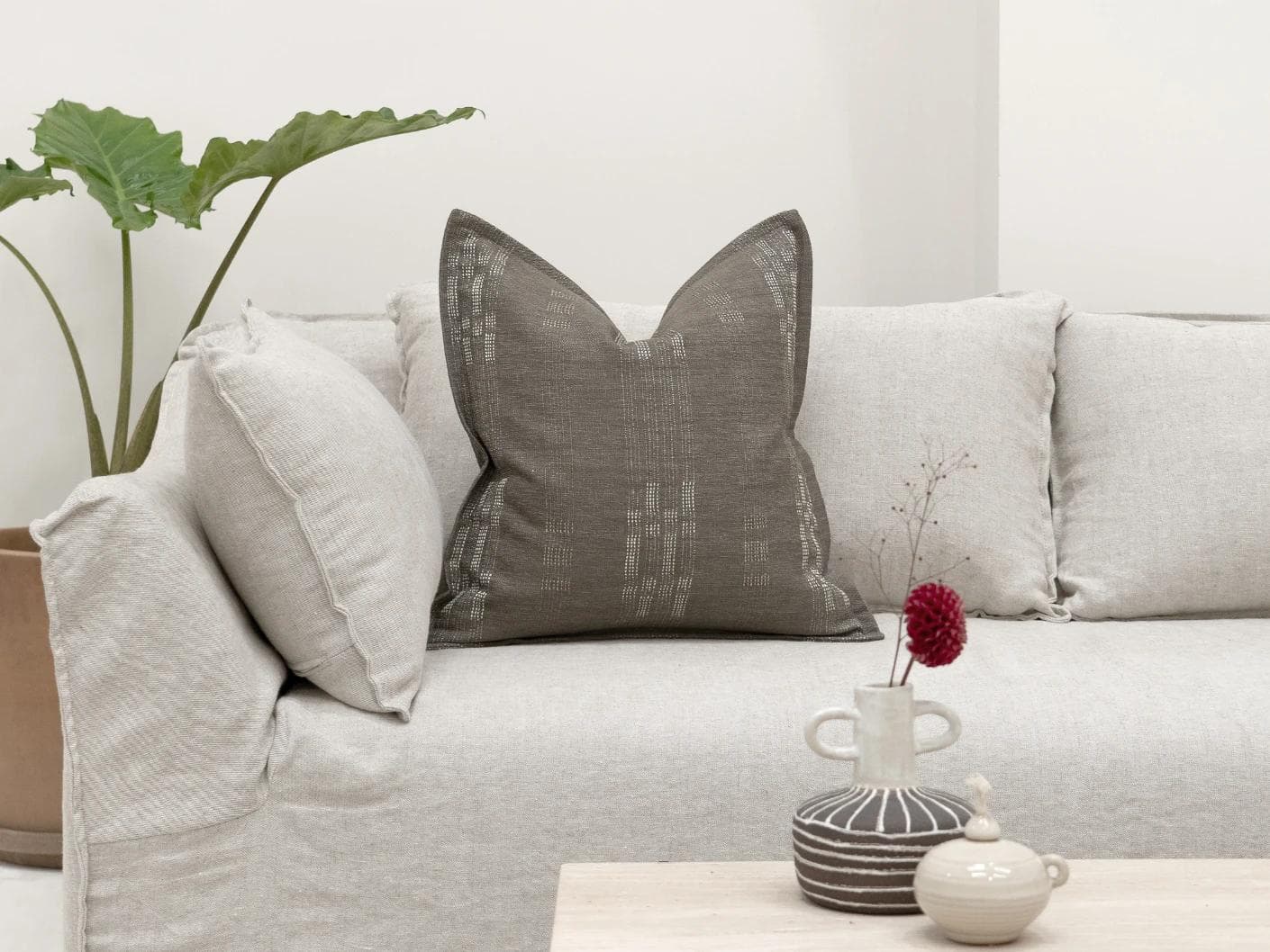 Yon Laurent cushion in taupe and charcoal, shown in a lifestyle front view as image 4