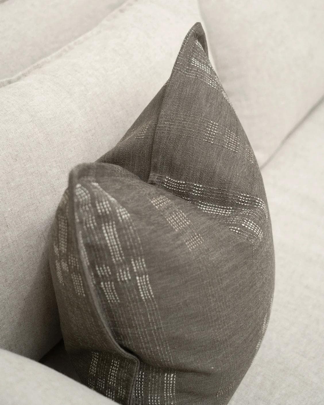 Yon Laurent cushion in taupe and charcoal, shown in a lifestyle top view as image 5