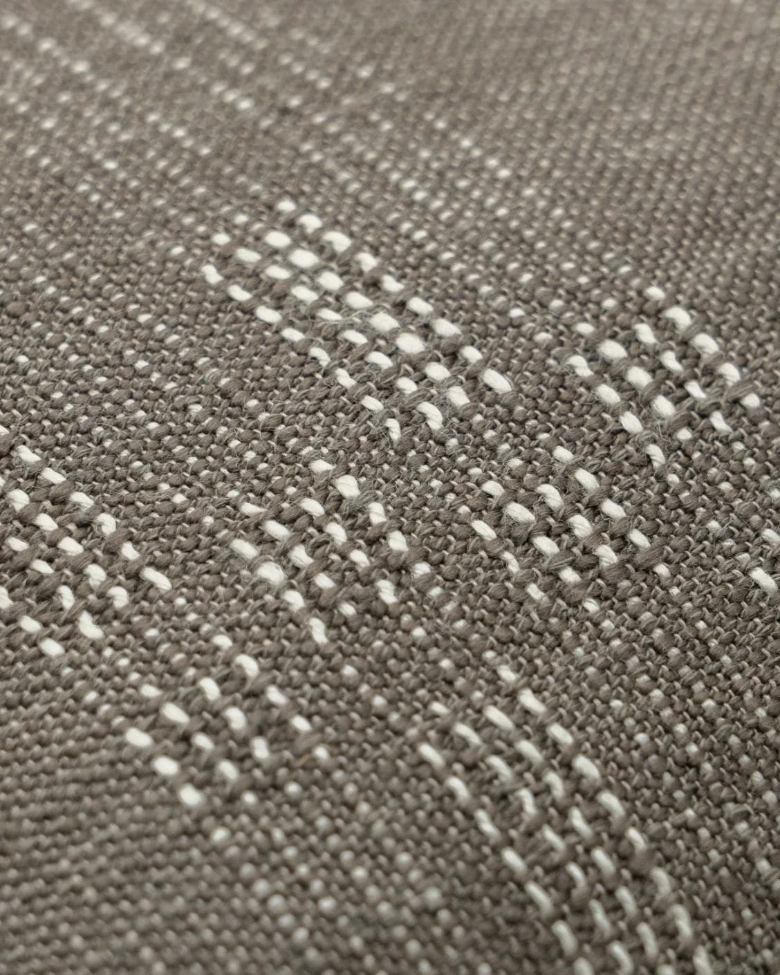 Yon Laurent cushion in taupe and charcoal, shown in a product close-up as image 6