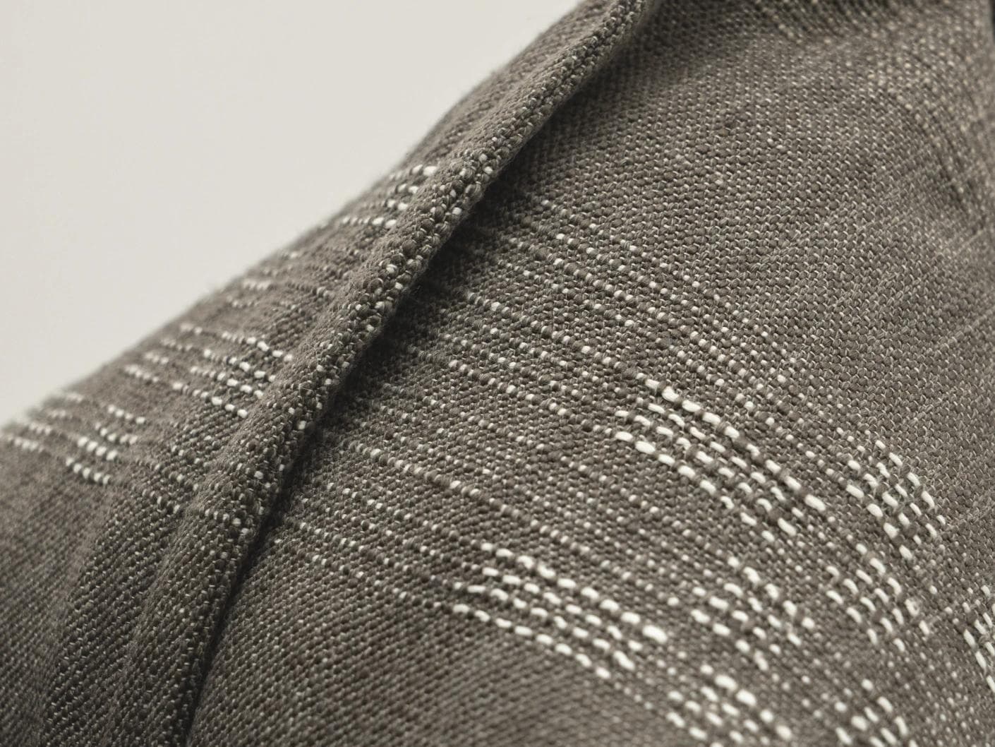 Yon Laurent cushion in taupe and charcoal, shown in a product close-up as image 7