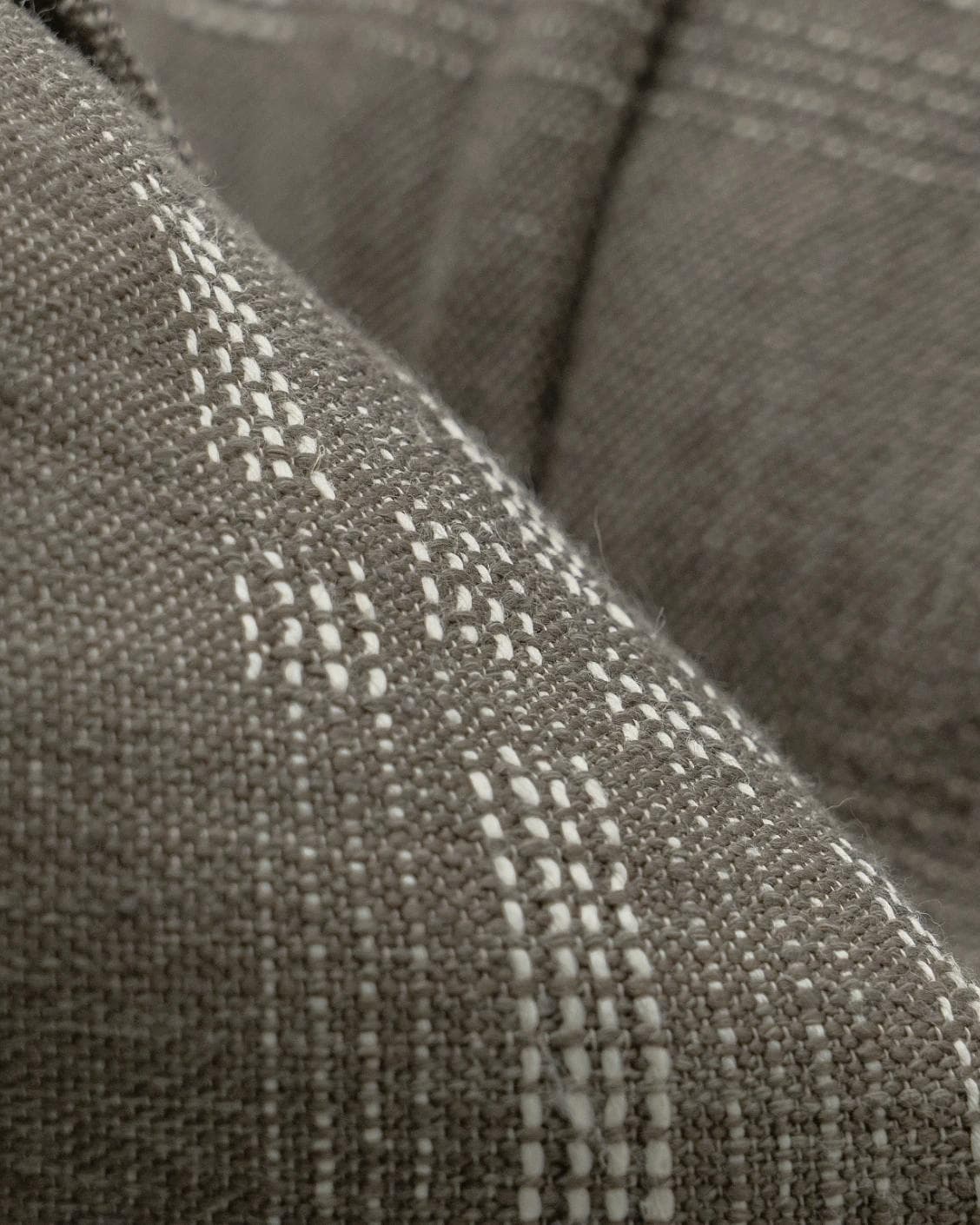 Yon Laurent cushion in taupe and charcoal, shown in a product close-up as image 8