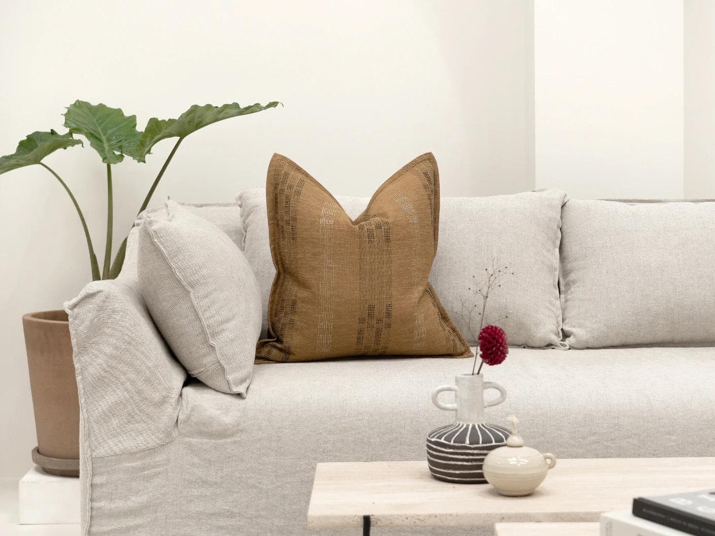 Yon Ochre cushion in ochre brown, shown in a lifestyle front view as image 4