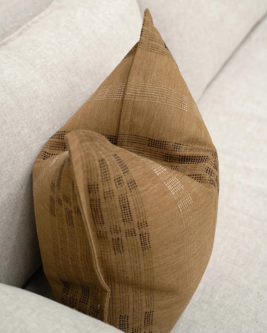 Yon Ochre cushion in ochre brown, shown in a lifestyle top view as image 5