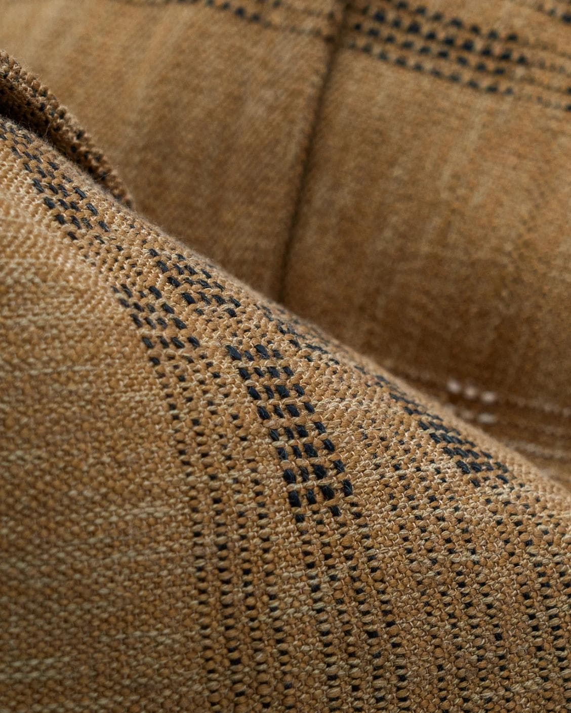 Yon Ochre cushion in ochre brown, shown in a product close-up as image 8
