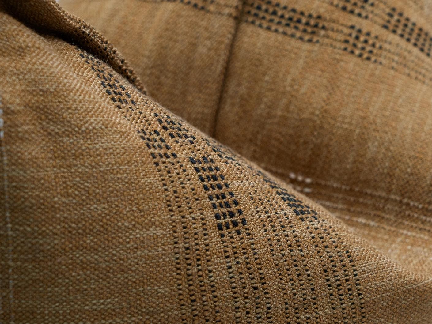 Yon Ochre cushion in ochre brown, shown in a product close-up as image 8