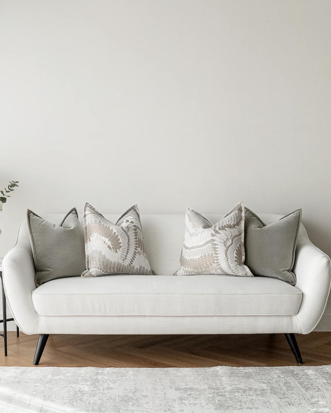 Yumi Bundle cushion in grey and brown, shown in a lifestyle front view as image 4