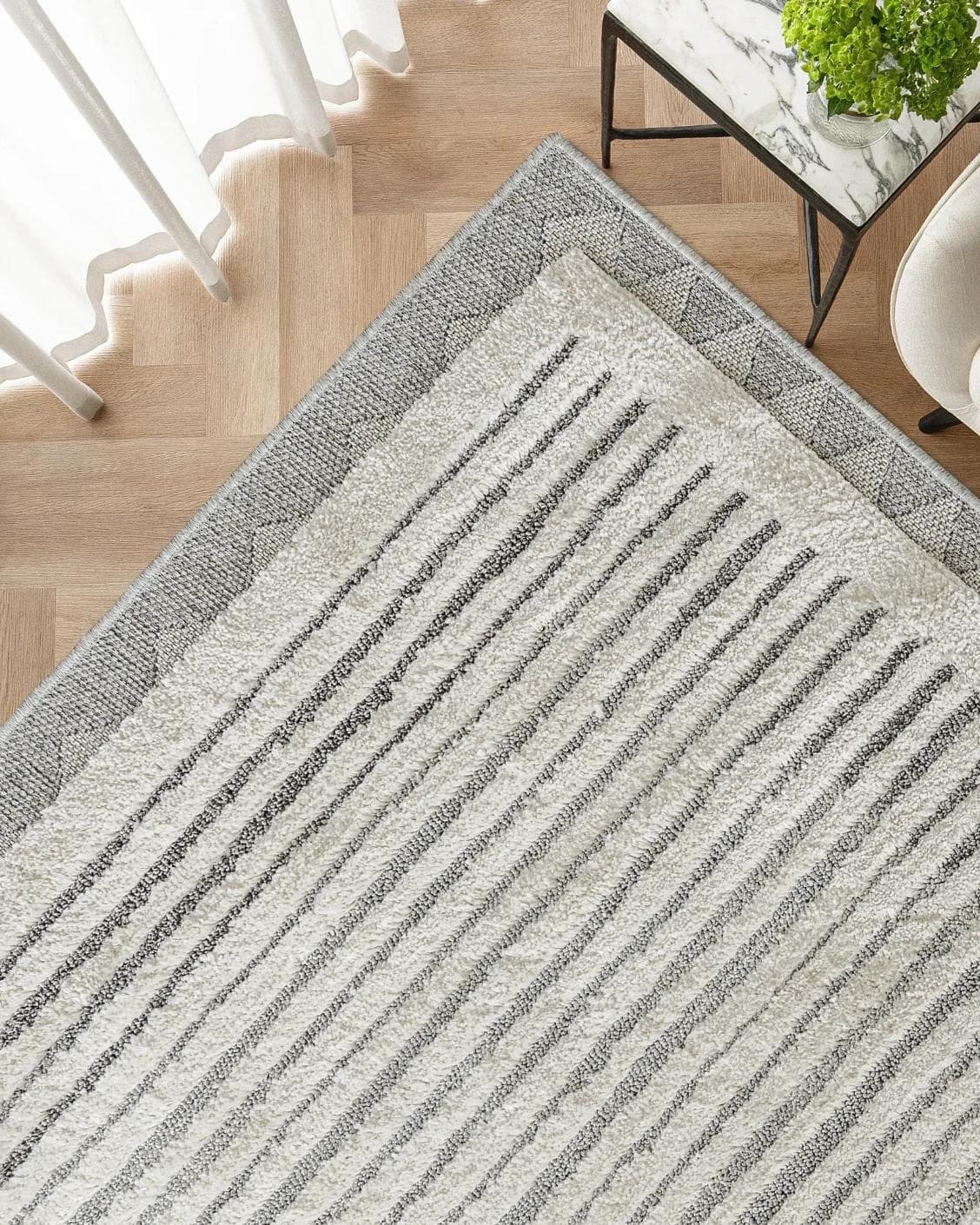 Zahra Alba carpet in ivory and grey, shown in a lifestyle top view as image 2