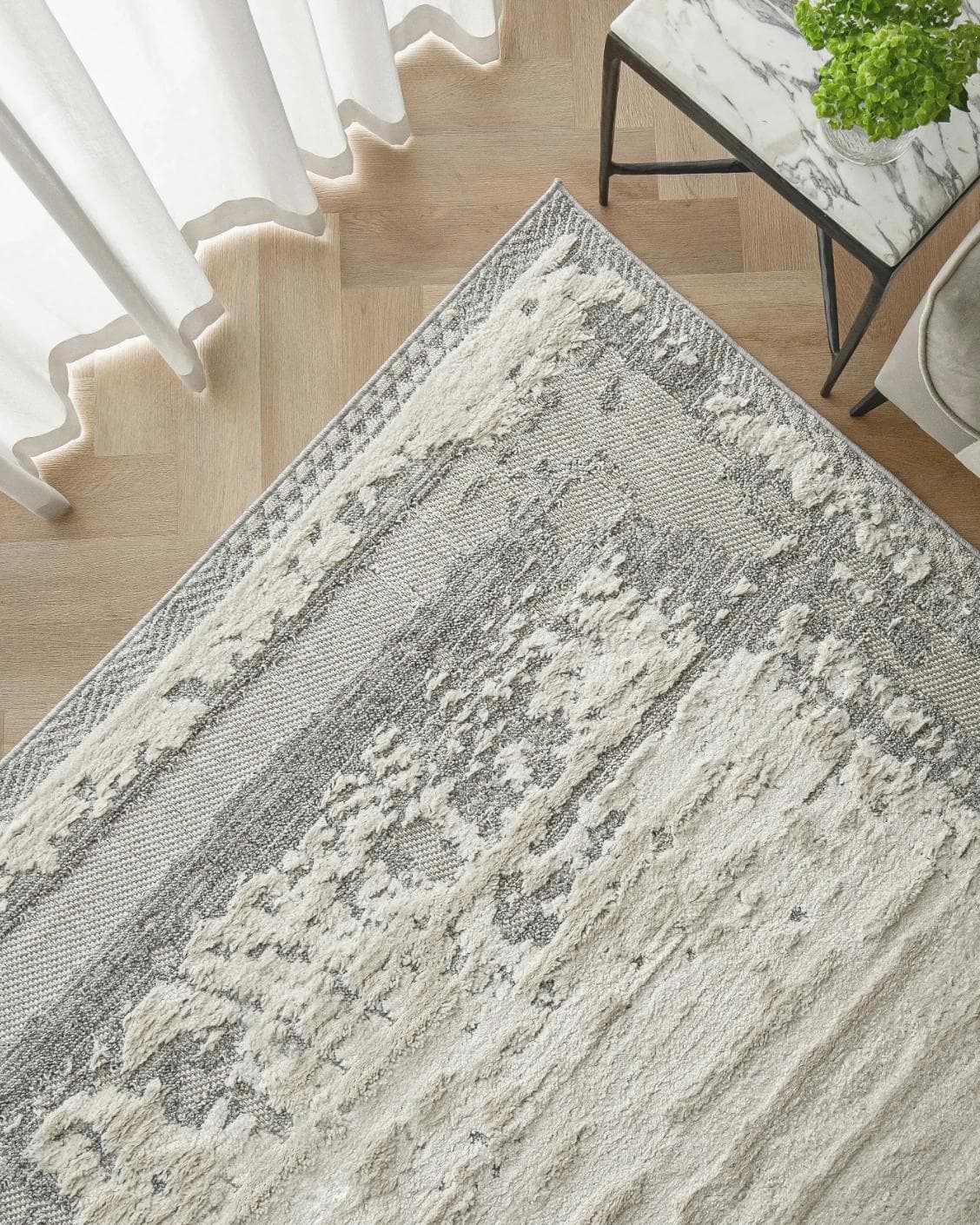 Zahra Bianca carpet in grey and ivory, shown in a lifestyle top view as image 2