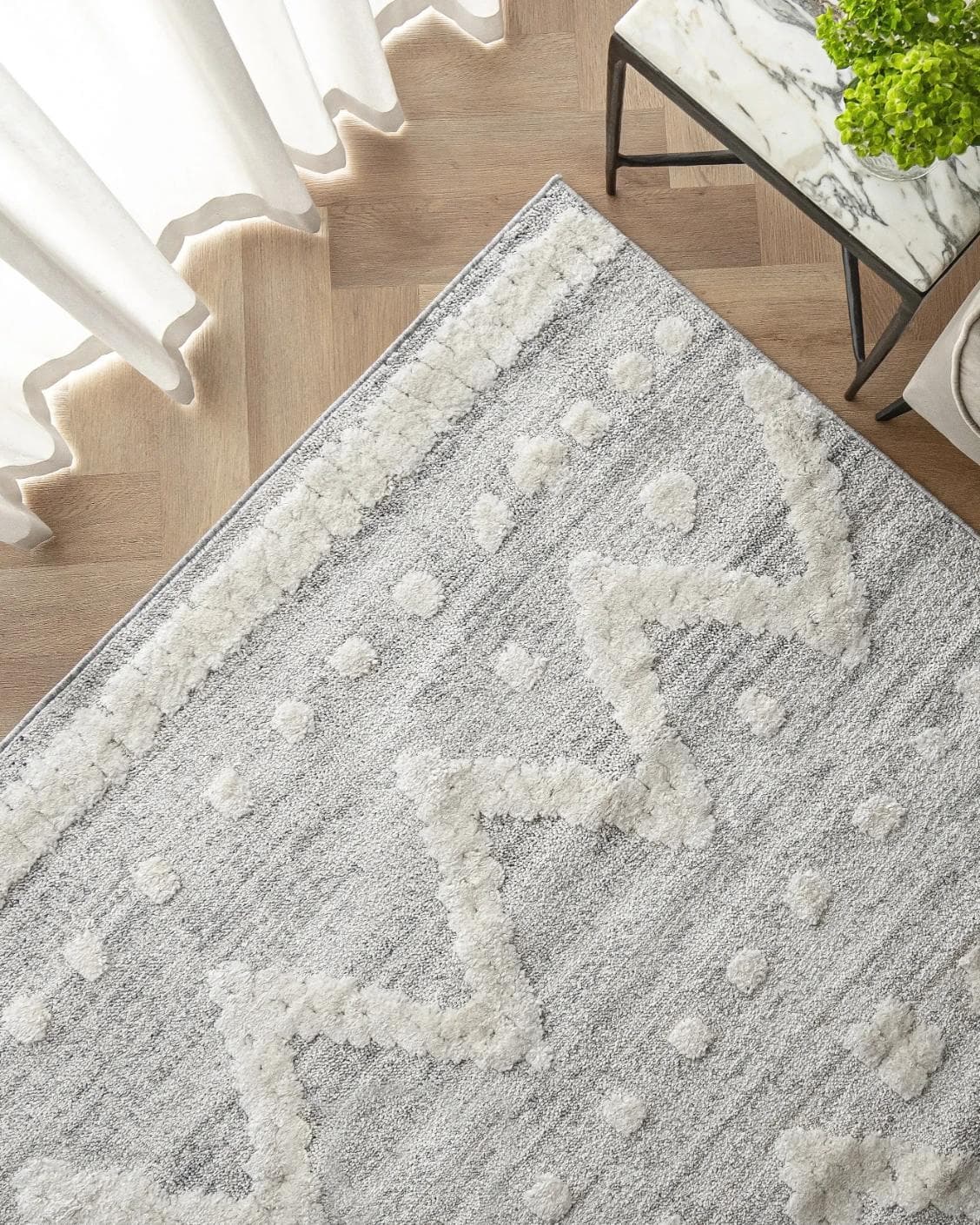 Zahra Snow carpet in grey and off white, shown in a lifestyle top view as image 2