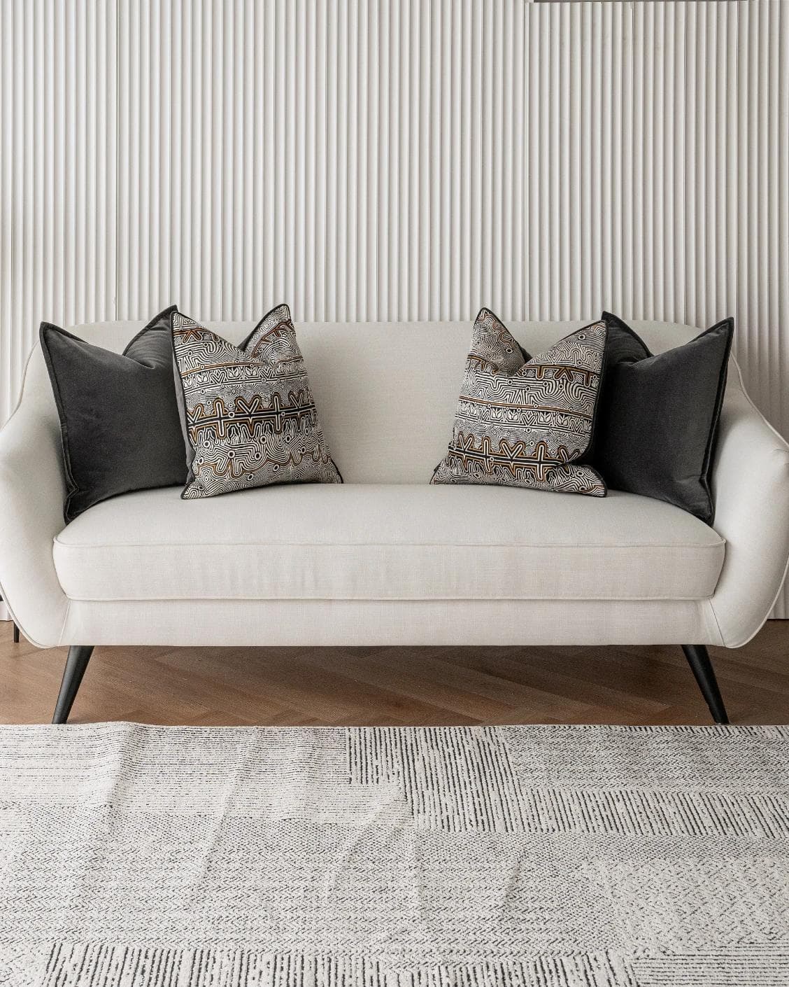 Zayn Bundle cushion in black, grey and silver, shown in a lifestyle front view as image 4