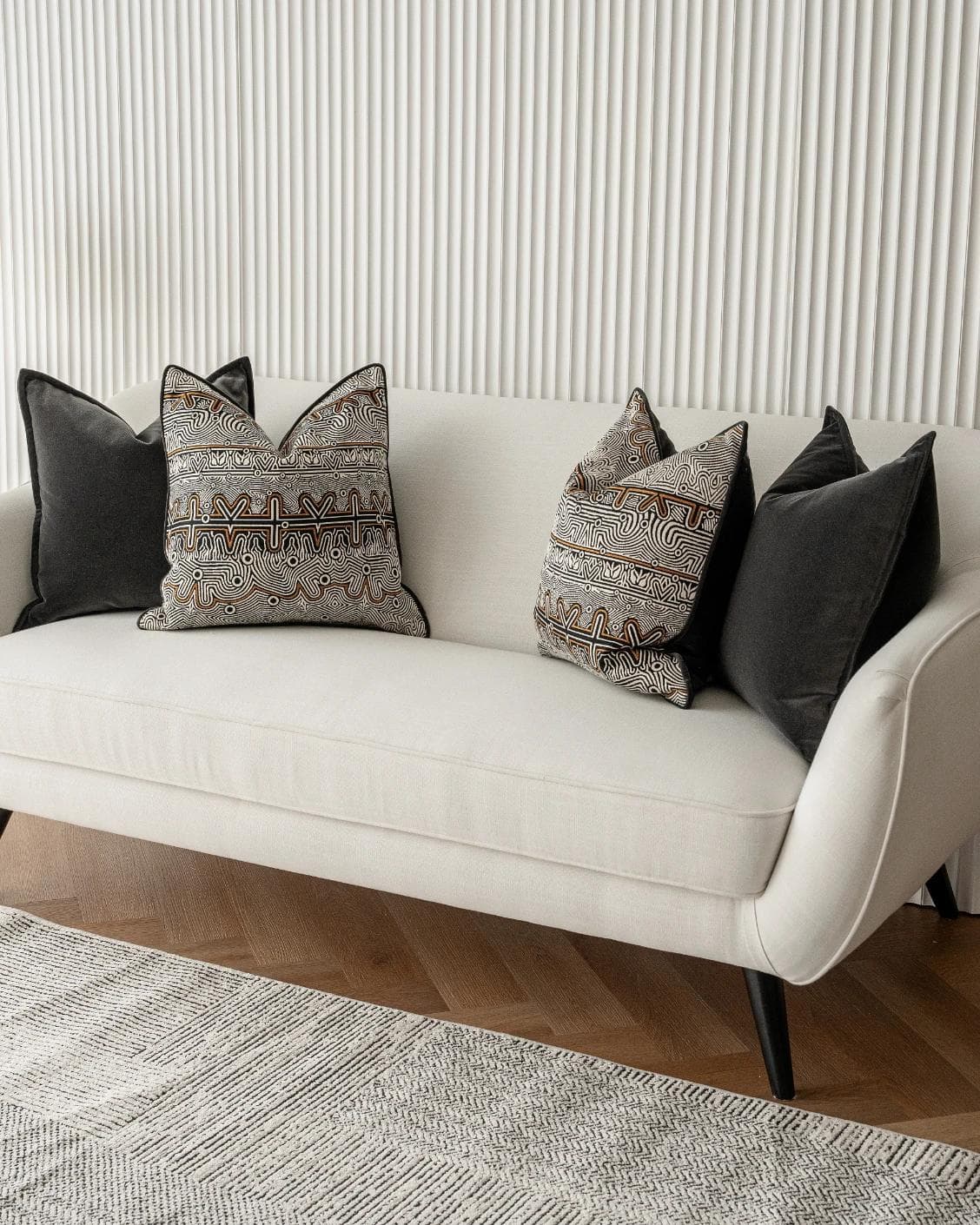 Zayn Bundle cushion in black, grey and silver, shown in a lifestyle right view as image 2