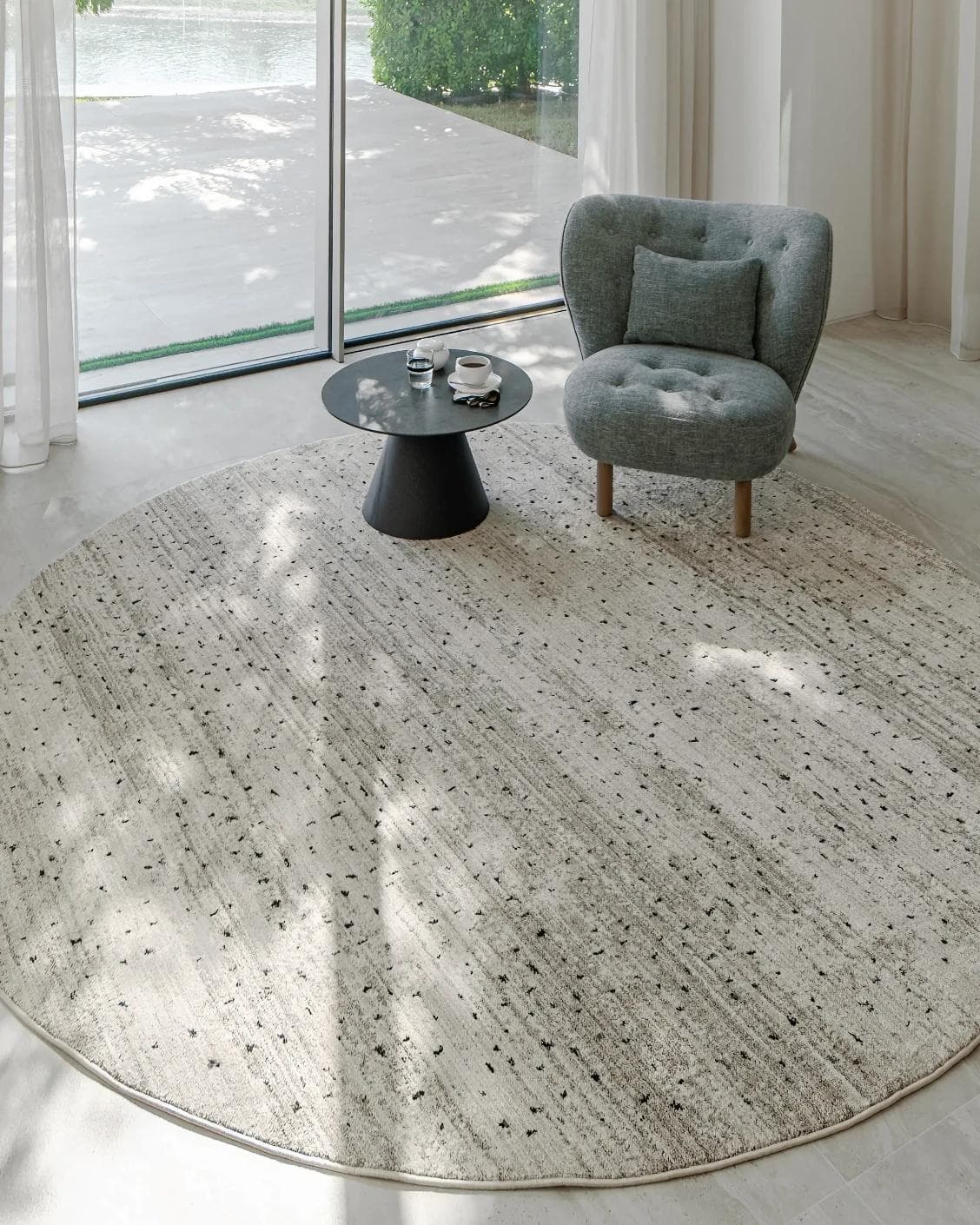 Zen Ashton Round carpet in beige, shown in a lifestyle top view