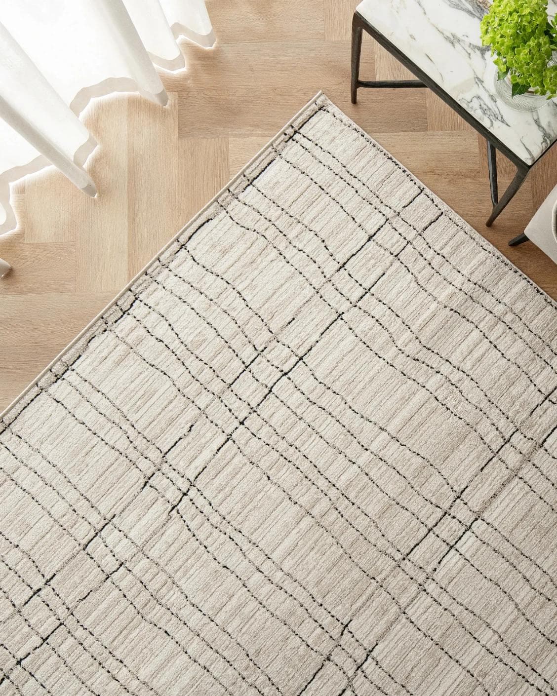 Zen Bianca carpet in charcoal and beige, shown in a lifestyle top view as image 2