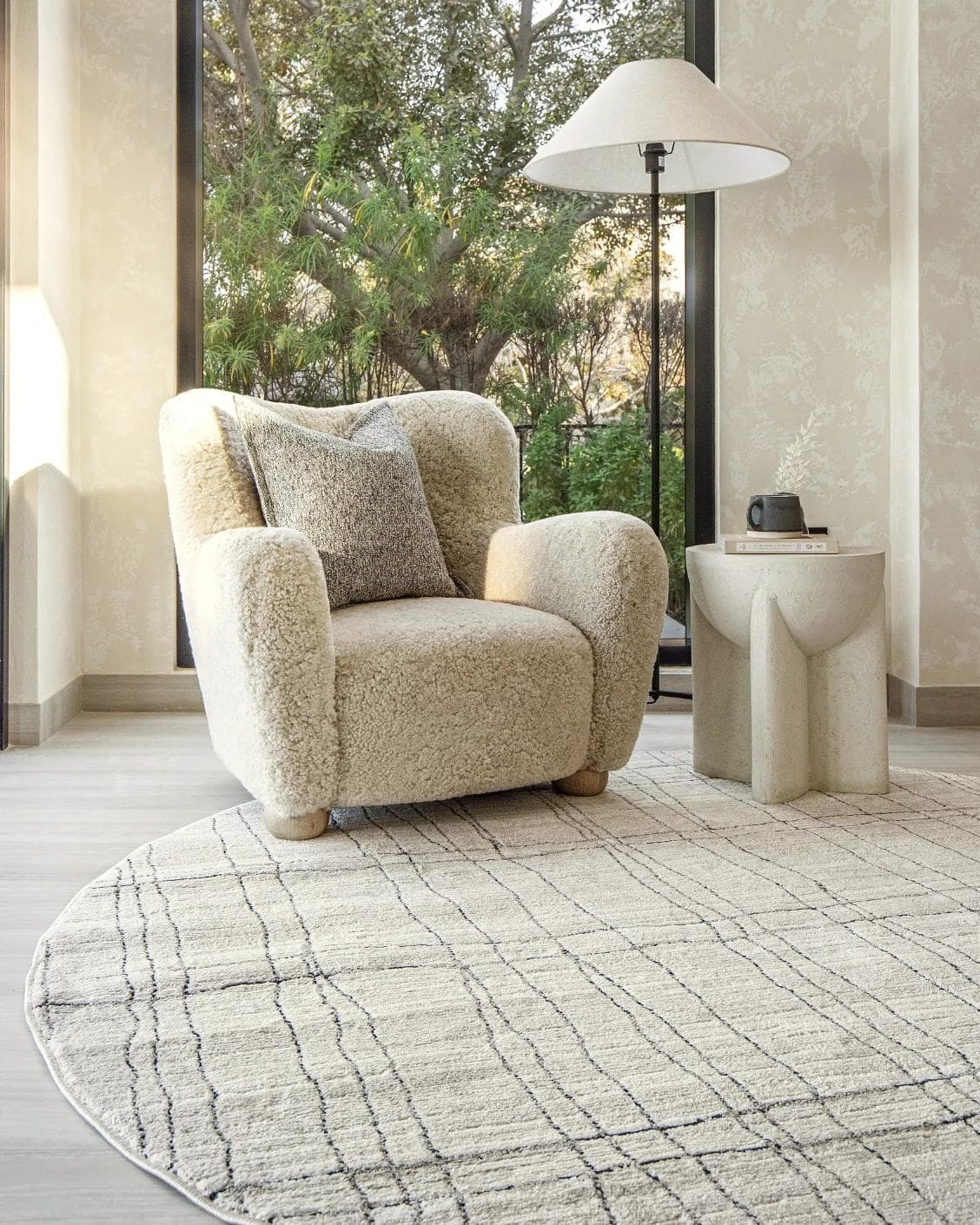 Zen Bianca Round carpet in charcoal and beige, shown in a lifestyle front view