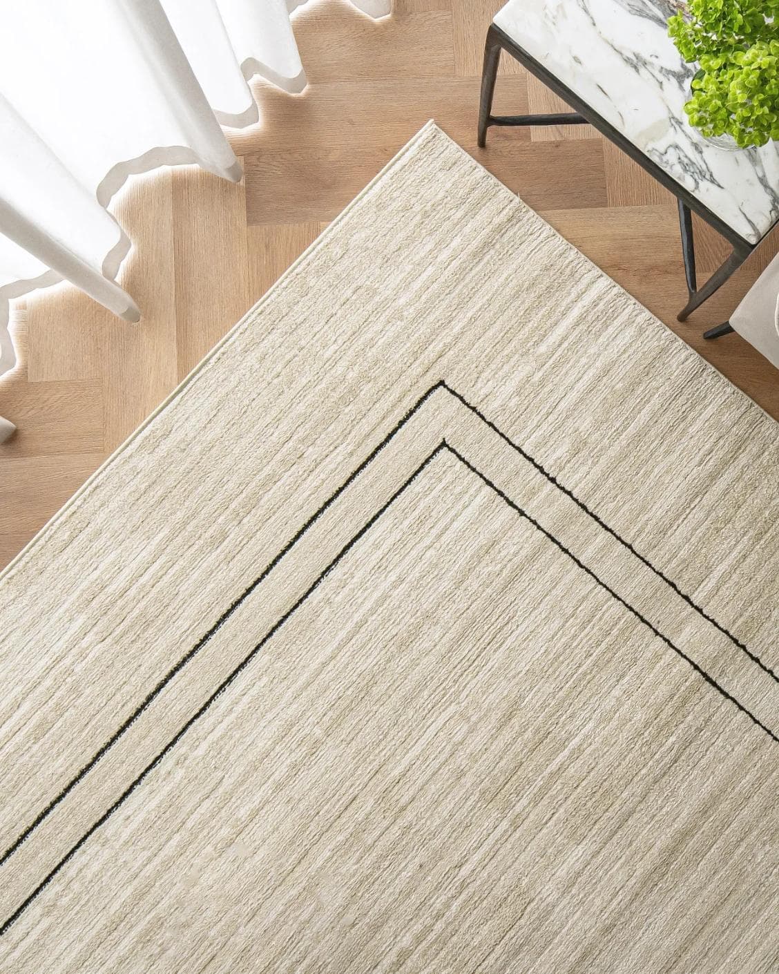 Zen Colin carpet in black and beige, shown in a lifestyle top view as image 2