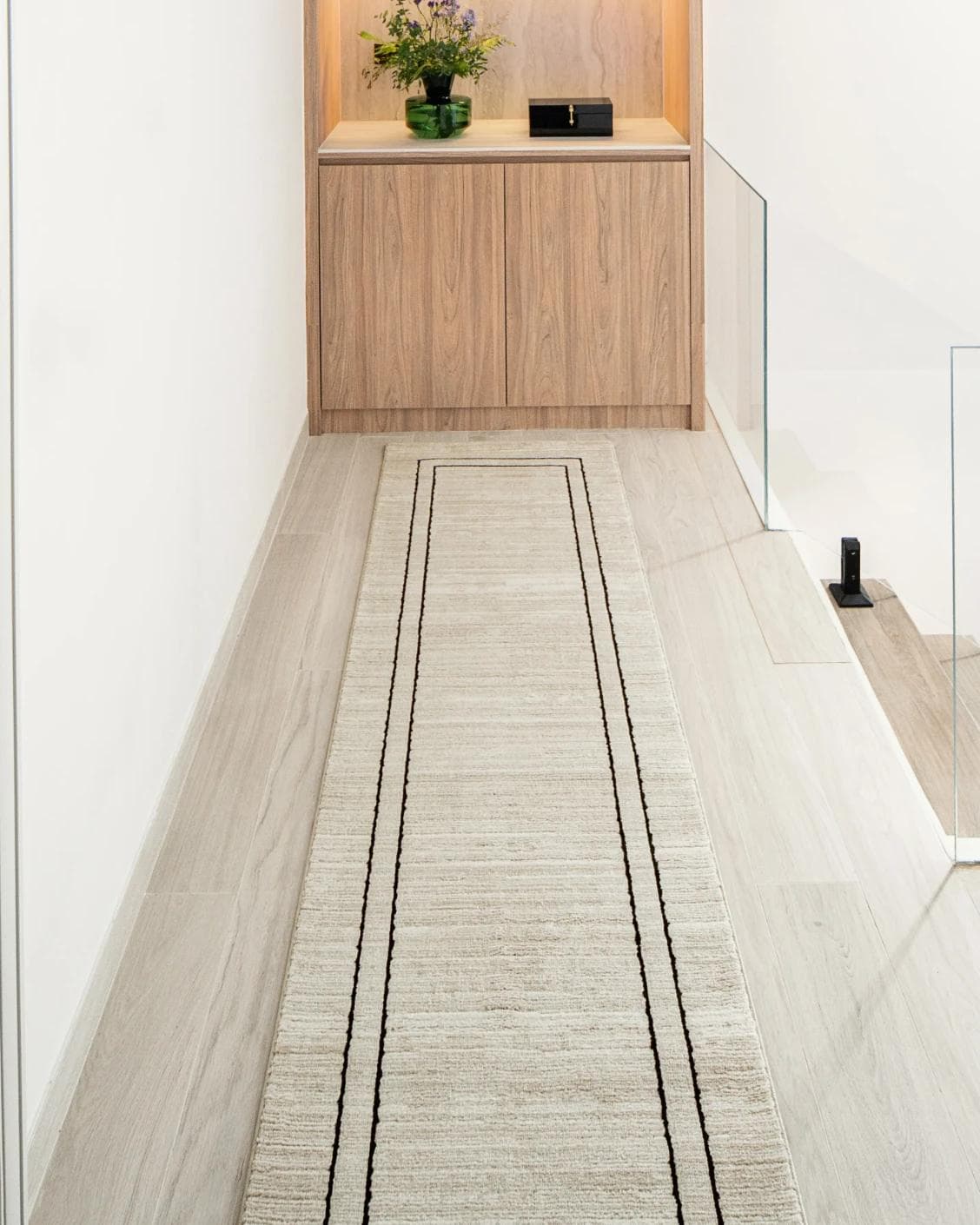 Zen Colin Runners carpet in black and beige, shown in a lifestyle front view