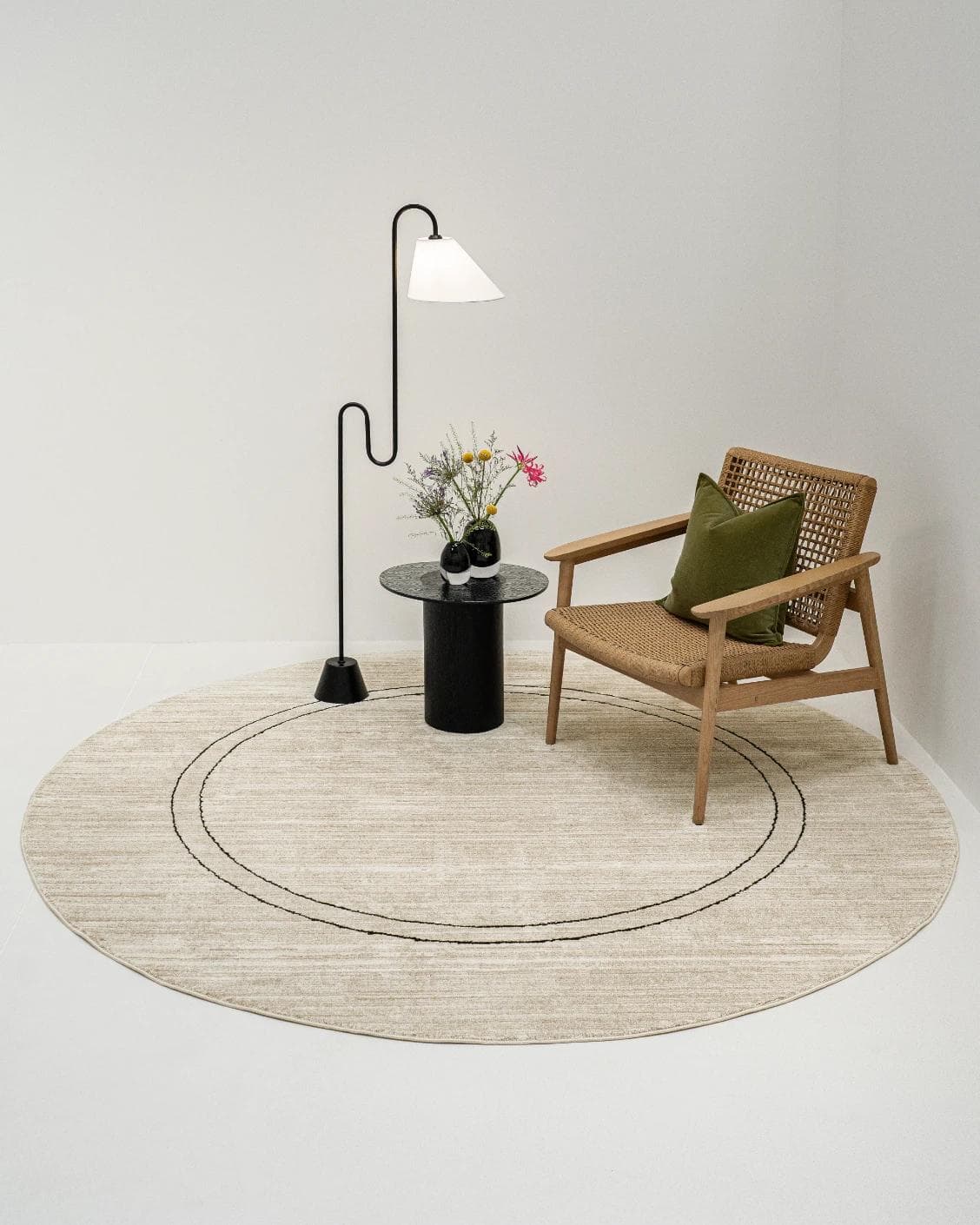 Zen Colin Round carpet in black and beige, shown in a lifestyle