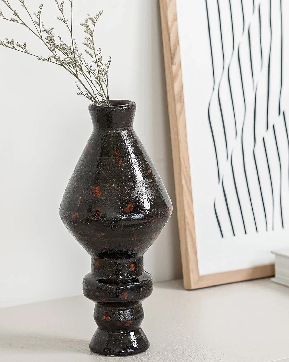 Zenith Terra I statues and sculptures in charcoal black and black, shown in a lifestyle left view as image 2