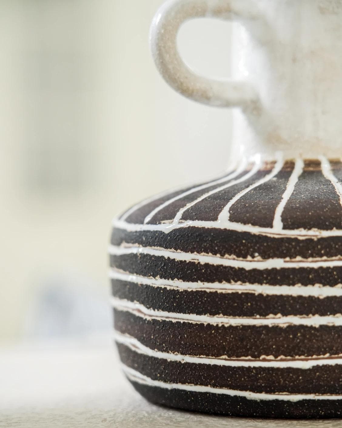 Zyra Terra vases in charcoal black, charcoal and white, shown in a lifestyle close-up as image 4