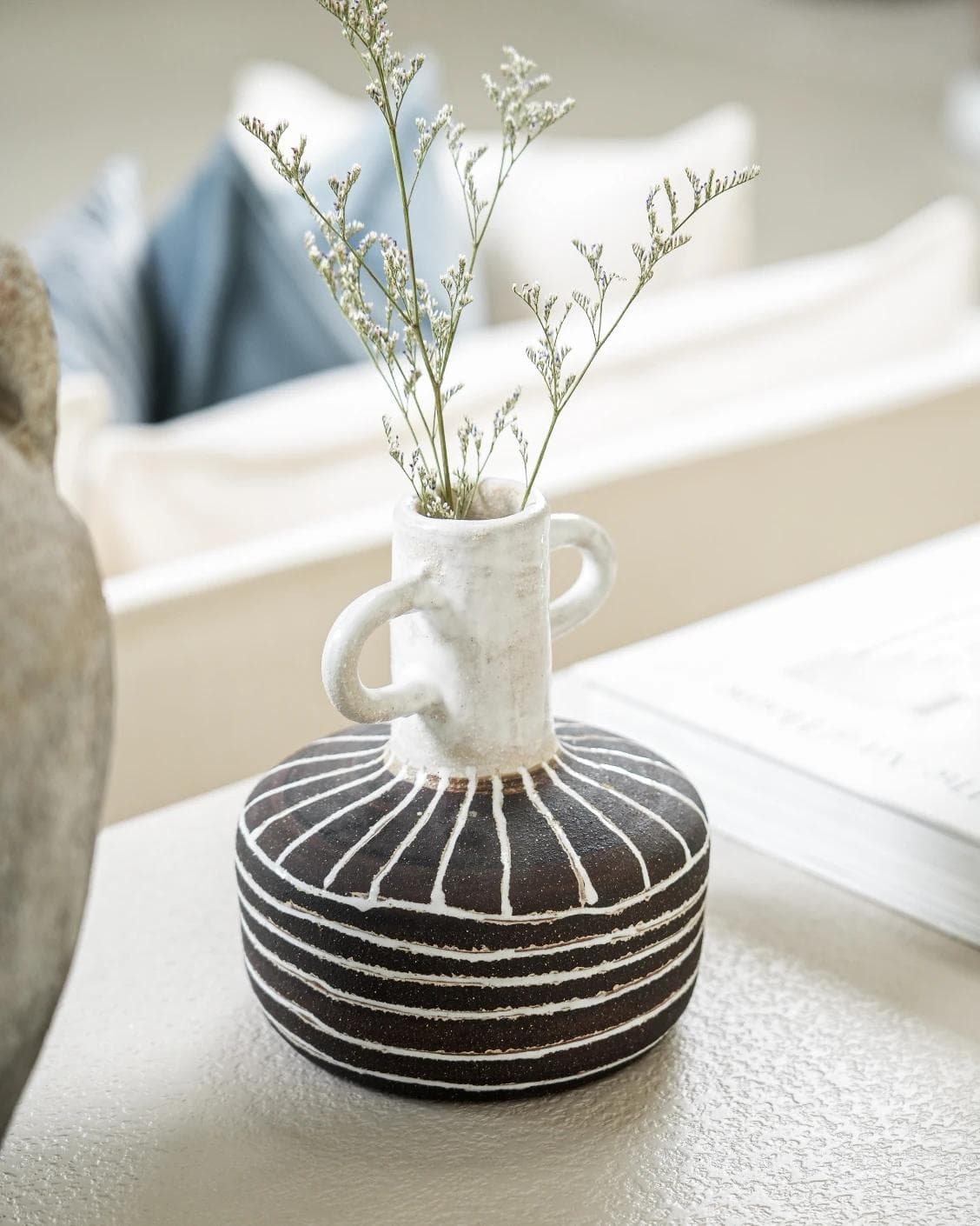 Zyra Terra vases in charcoal black, charcoal and white, shown in a lifestyle right view as image 2