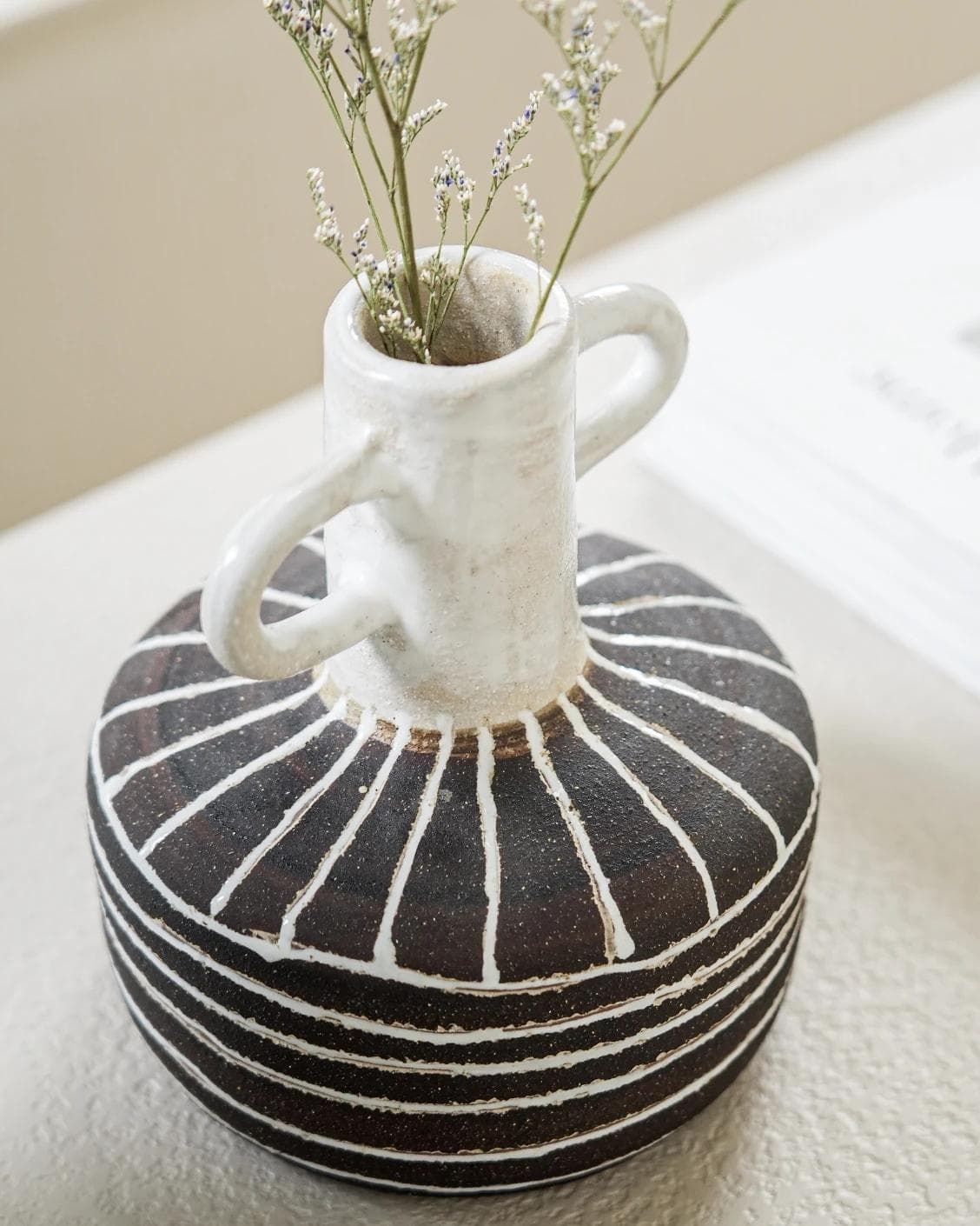 Zyra Terra vases in charcoal black, charcoal and white, shown in a lifestyle top view as image 6